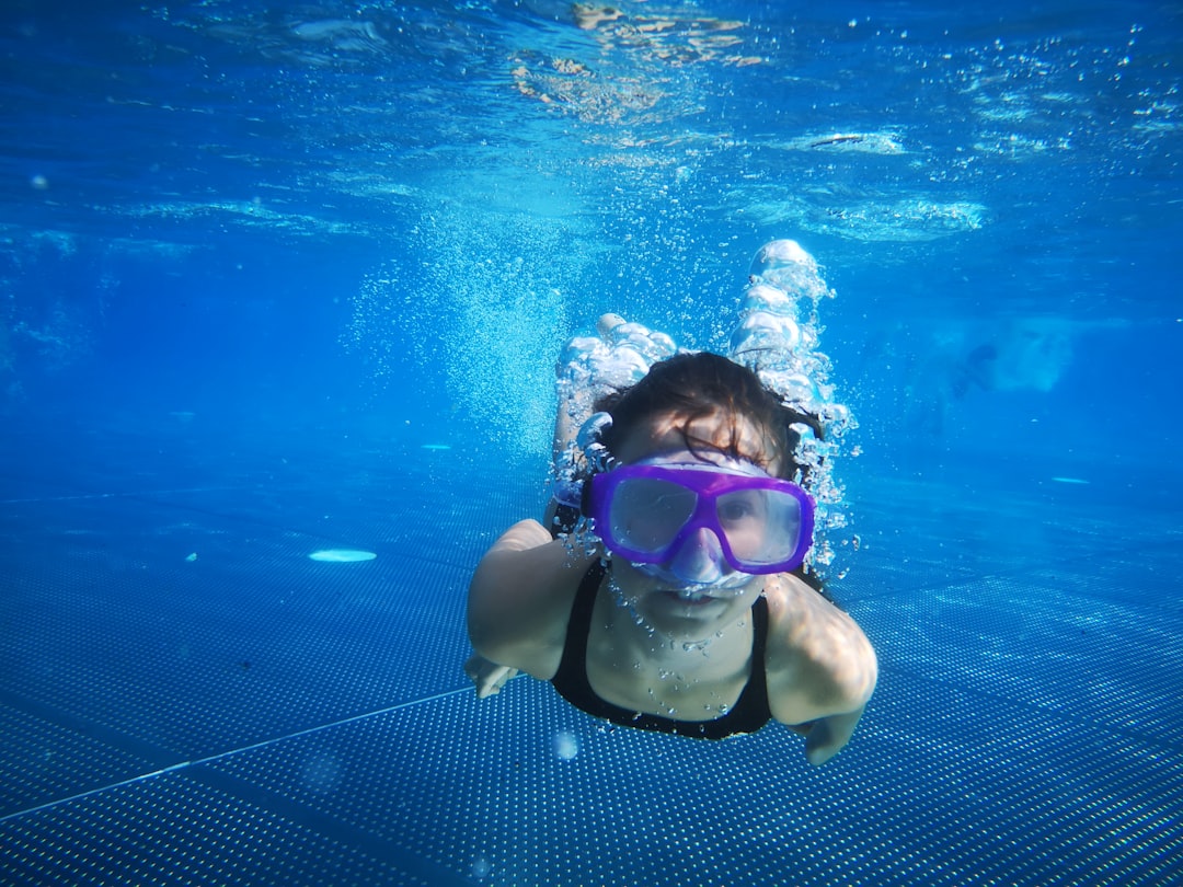 person wearing blue goggles during daytime