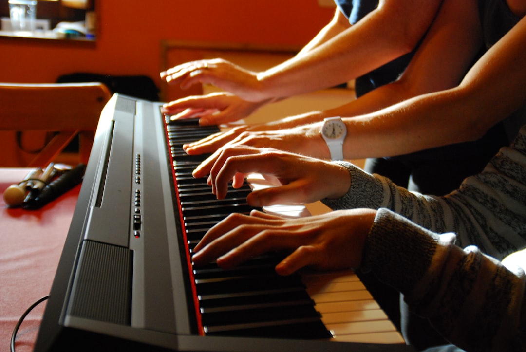 Someone is playing the piano with two keyboards.