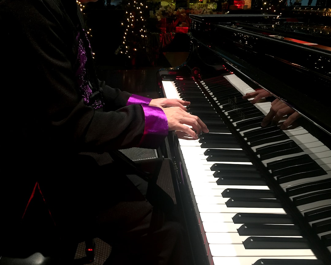 Someone is playing the piano with two keyboards.